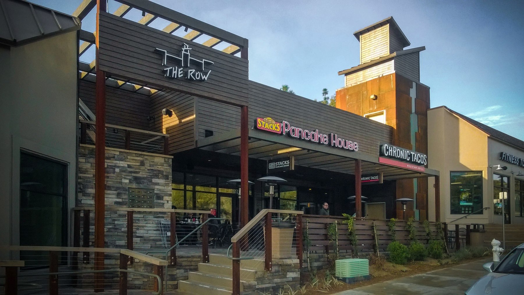 Storefronts along The Row, including Stacks Pancake House and Chronic Tacos